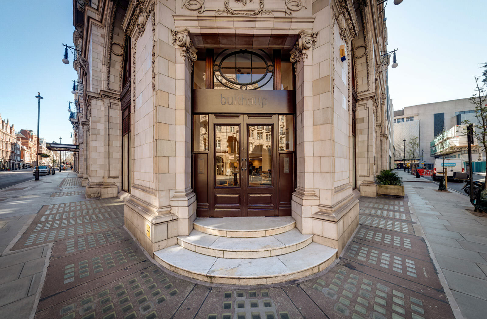 Door of bulthaup's virtual showroom - showing the view as customers step up to the door of the actual showroom in Mayfair. It's a grand stone entrance with a large glazed wooden double doorway.