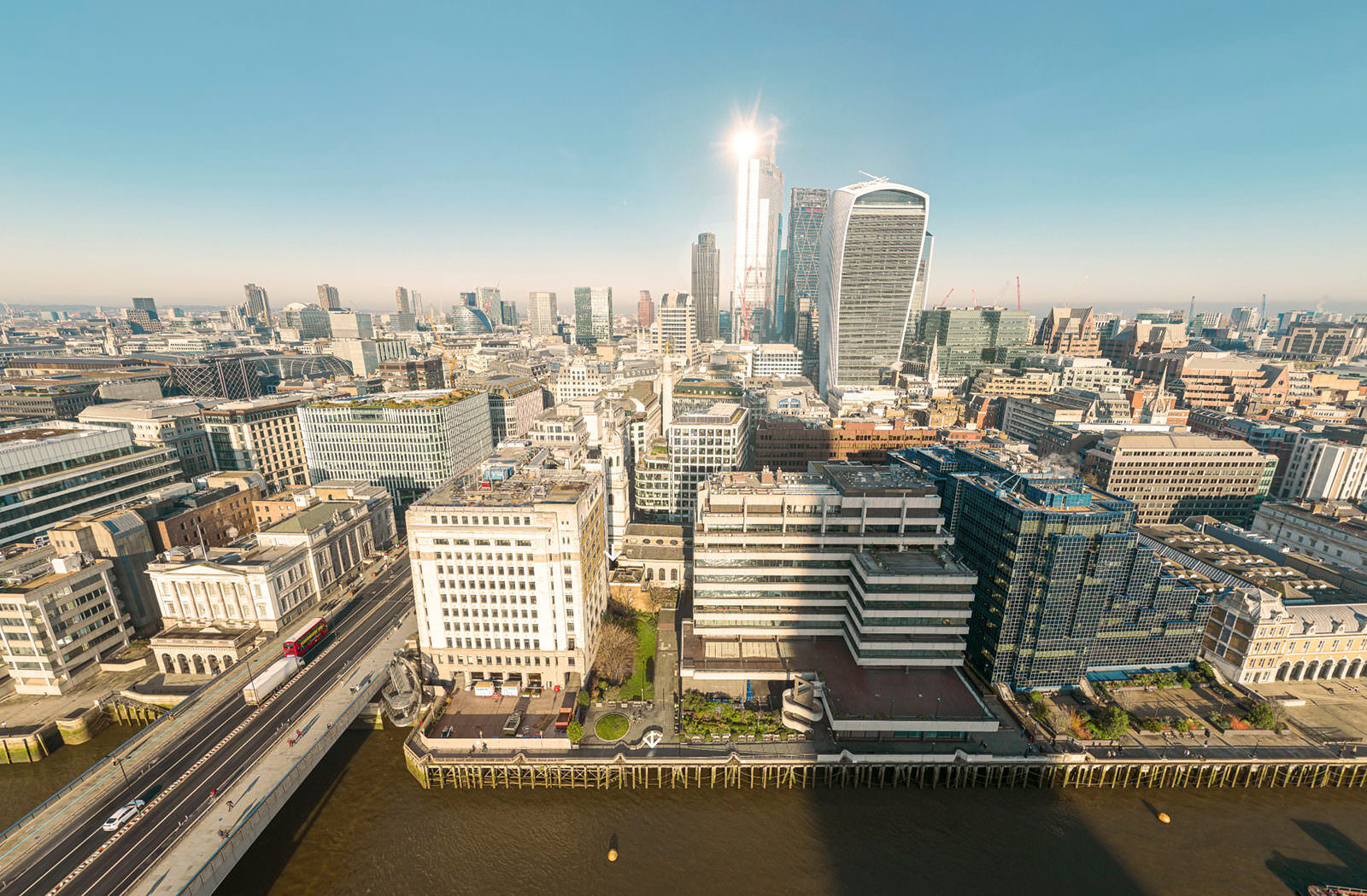 Still image taken from the aerial 360 for the St Magnus Church virtual tour. The image is taken from high above the River Thames and shows London Bridge, St Magnus the Martyr and Adelaide house, with the City of London in view behind them.