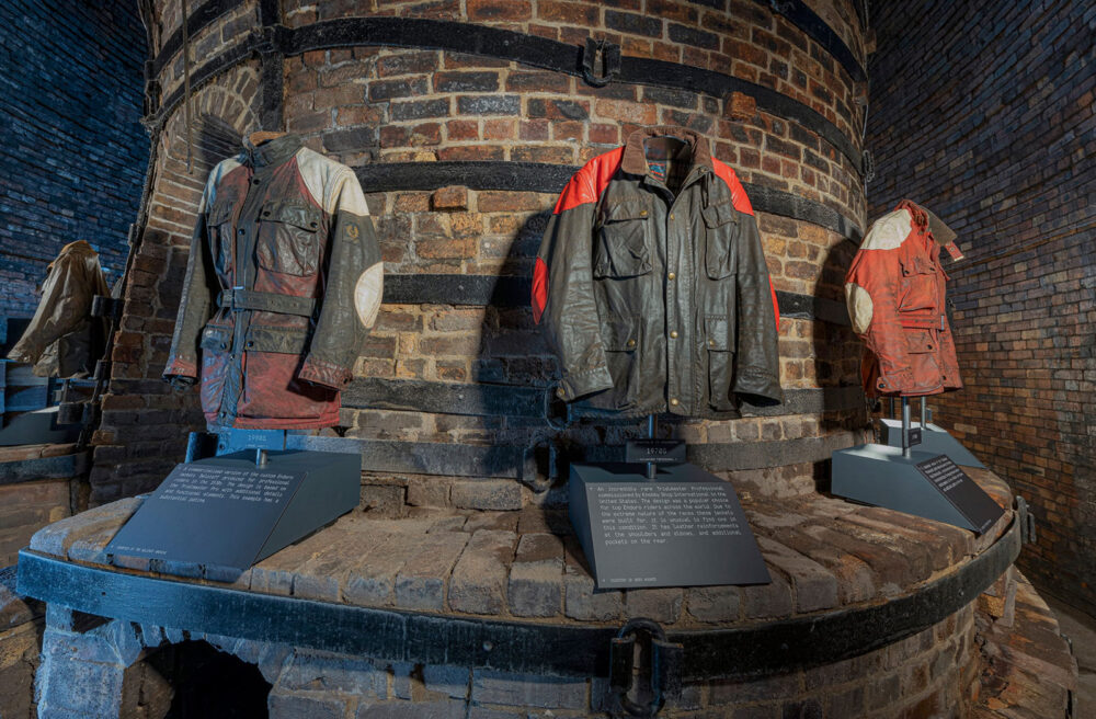 Crop from a 360 image showing some of the exhibits at the Belstaff 100 years exhibition. This shows three jackets hanging, the central one having belonged to Steve McQueen who was a keen trials rider.