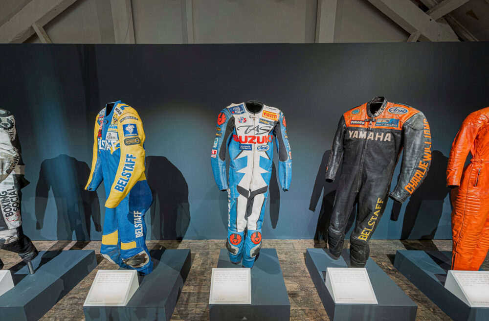 Crop from a 360 image showing some of the exhibits at the Belstaff 100 years exhibition virtual tour. This image shows three full leather motorbike suits.