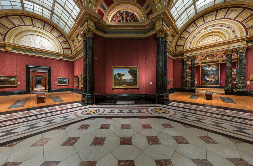 National Gallery virtual tour - still of Room 36 taken from the tour. A rich burgundy-papered room and a geometric marble tiled floor is visible in the room, with artworks visible in Room 36 and the surrounding Barry Rooms